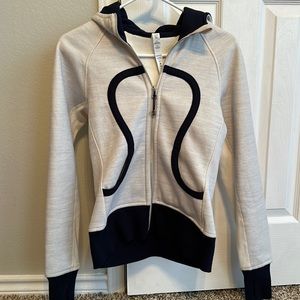 Lululemon hooded zip up, blue accent color, size 4, no tag, never worn.